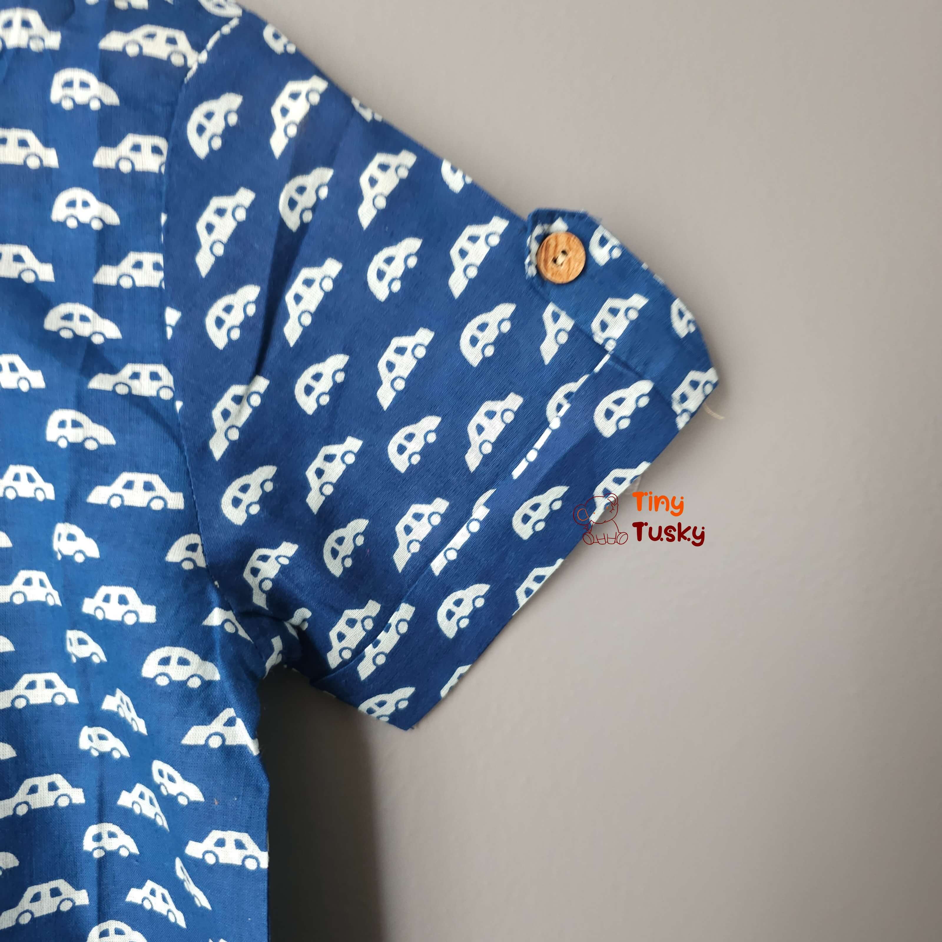 Tiny Tusky Boys Blue Cotton Car Shirt! Crafted from 100% breathable cotton, this comfortable shirt is perfect for keeping your boy cool and comfortable all day long. Featuring a playful car motif in a rich dark Blue color, this shirt is sure to spark his imagination and become a summertime favorite.