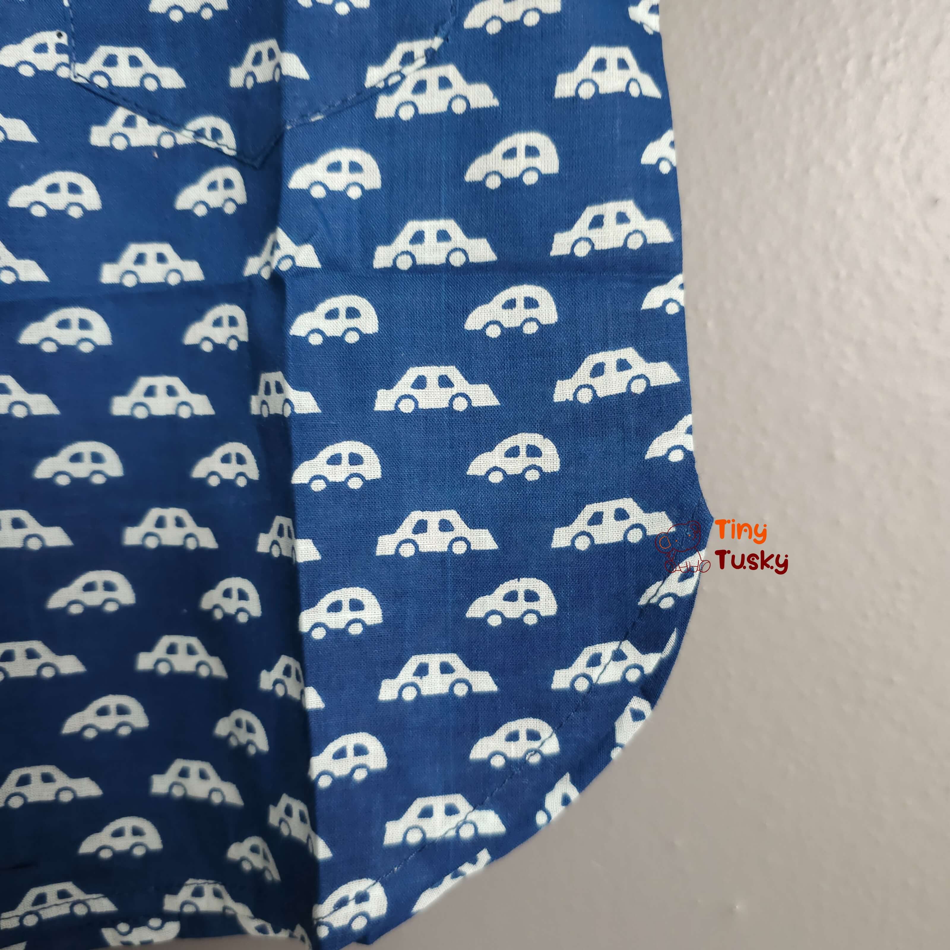 Tiny Tusky Boys Blue Cotton Car Shirt! Crafted from 100% breathable cotton, this comfortable shirt is perfect for keeping your boy cool and comfortable all day long. Featuring a playful car motif in a rich dark Blue color, this shirt is sure to spark his imagination and become a summertime favorite.