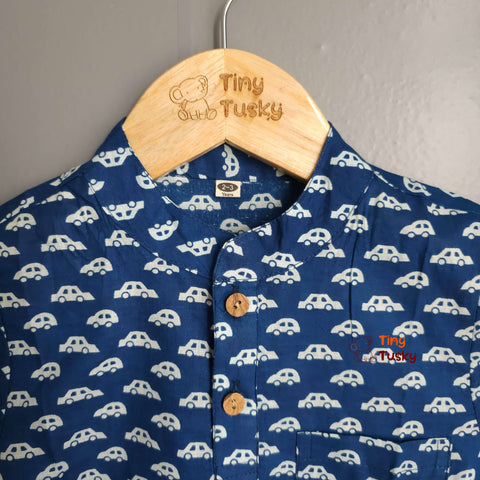 Tiny Tusky Boys Blue Cotton Car Shirt! Crafted from 100% breathable cotton, this comfortable shirt is perfect for keeping your boy cool and comfortable all day long. Featuring a playful car motif in a rich dark Blue color, this shirt is sure to spark his imagination and become a summertime favorite.