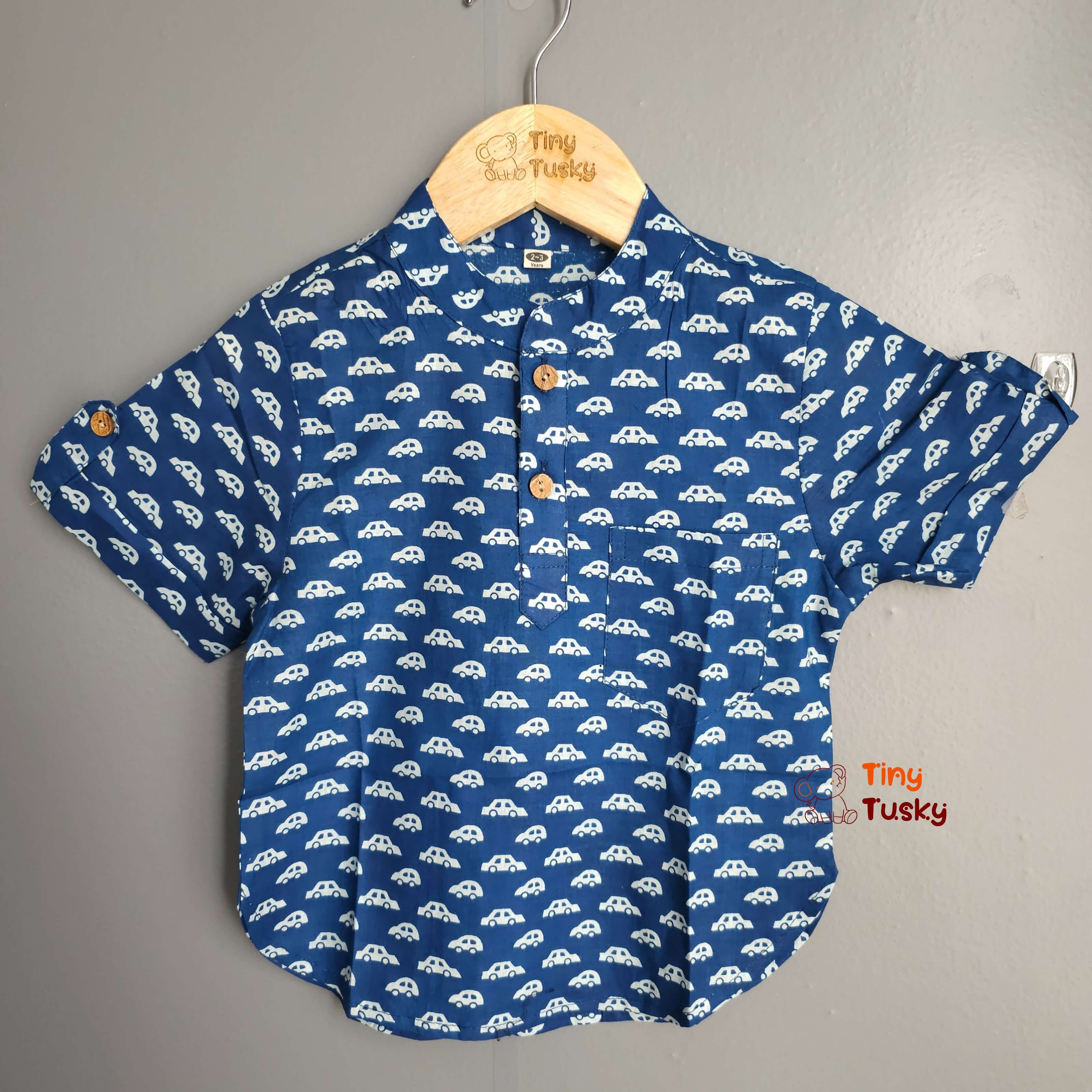 Tiny Tusky Boys Blue Cotton Car Shirt! Crafted from 100% breathable cotton, this comfortable shirt is perfect for keeping your boy cool and comfortable all day long. Featuring a playful car motif in a rich dark Blue color, this shirt is sure to spark his imagination and become a summertime favorite.